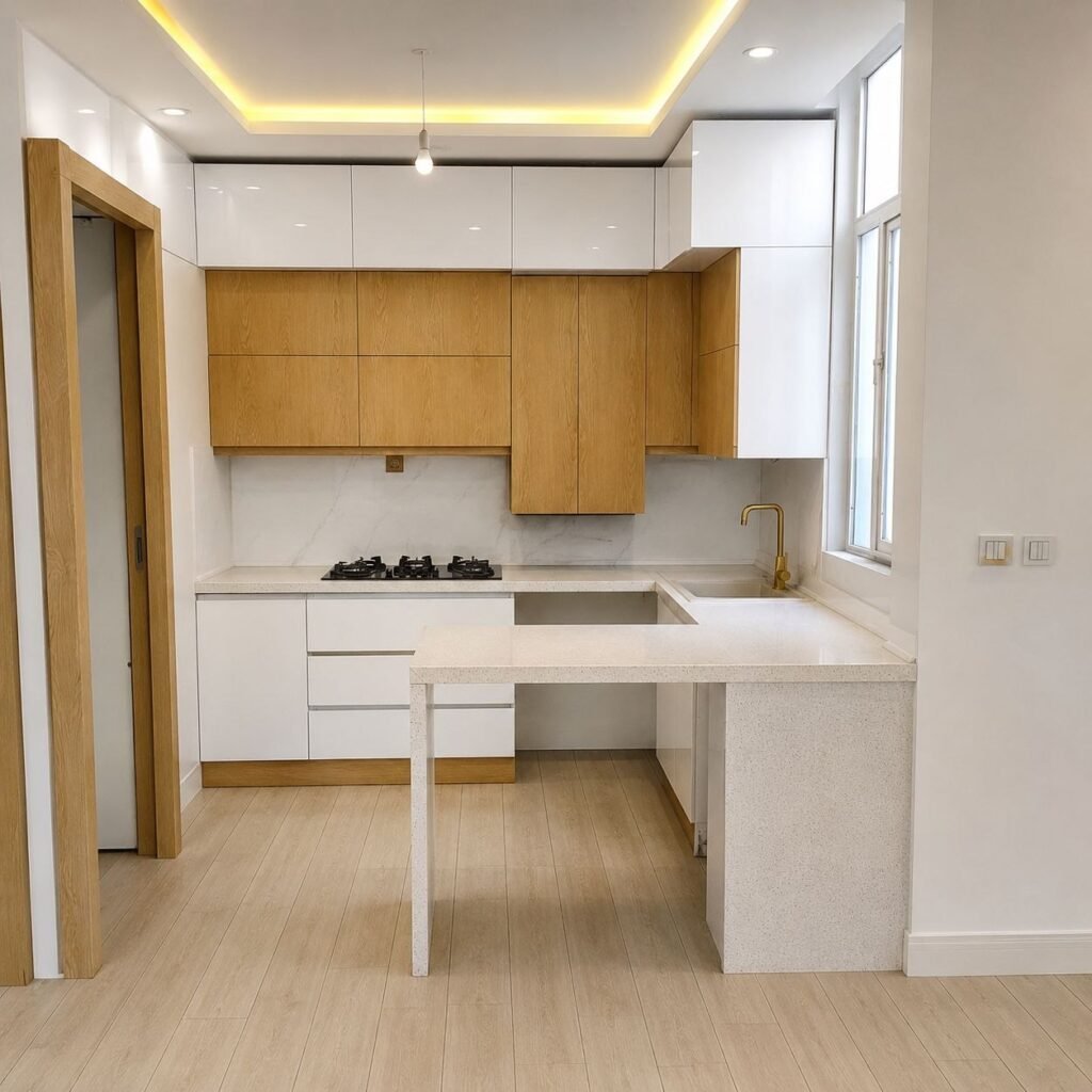 Modern minimalist kitchen renovation by Fardo Technical Services featuring white and wood grain cabinets, quartz countertops, and a gold faucet.